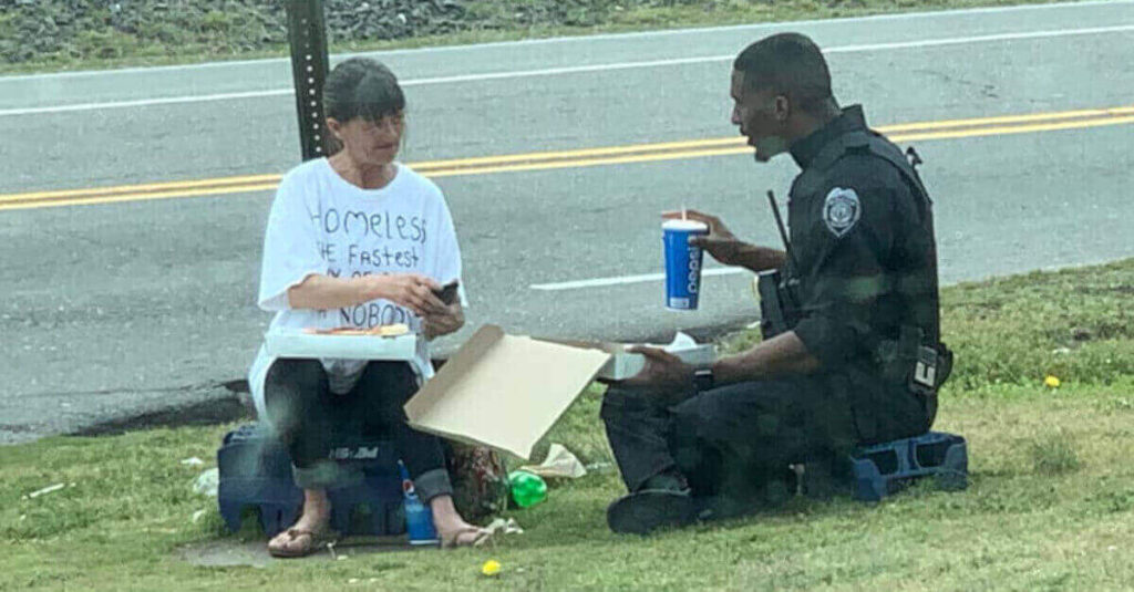 Poliziotto compra una pizza e la condivide con una senzatetto, la foto fa il giro del mondo